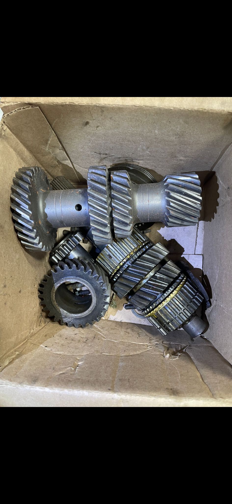 Close-up of a transmission gearset assembly in a cardboard box
